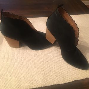 Black scalloped booties by Qupid